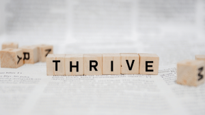 Blocks with letters spelling the word "thrive."