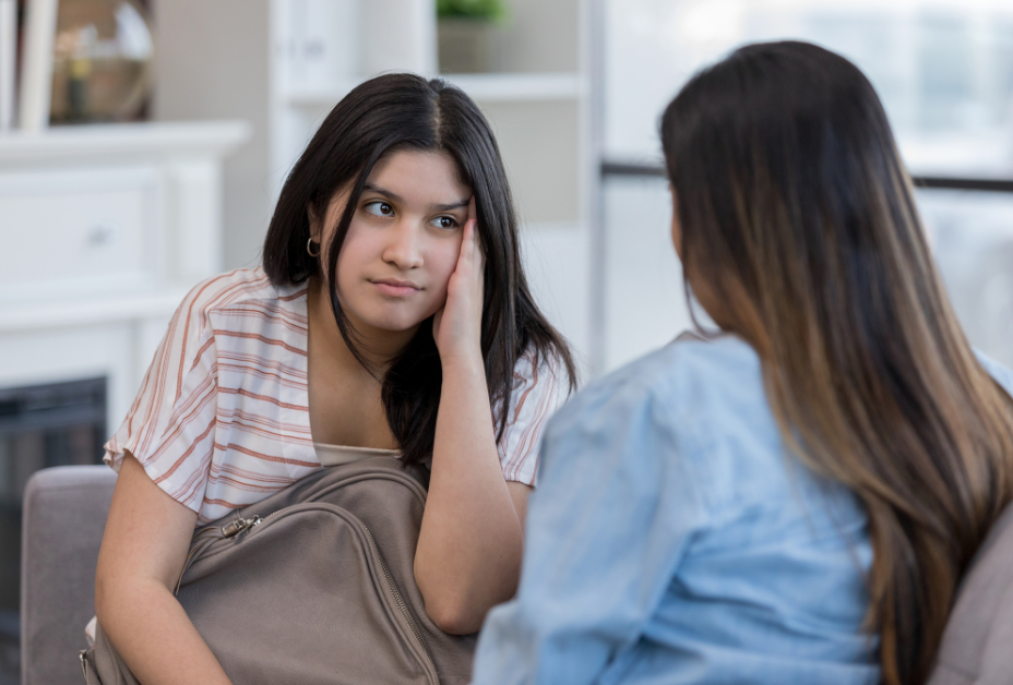 Young teen in conversation with her mom.