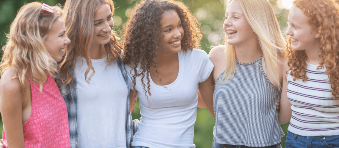 5 teenage daughters arms around each other