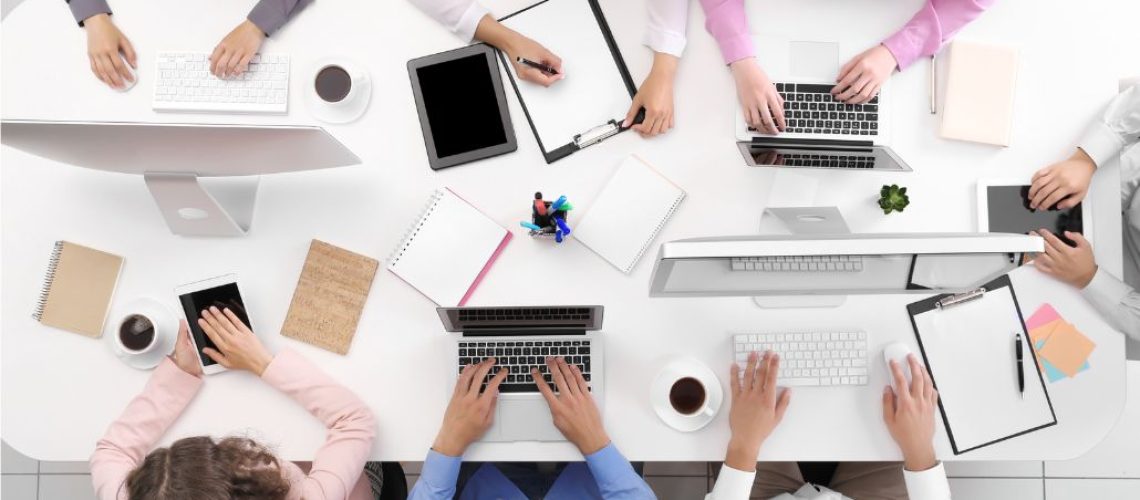 Picture of a group of students sitting working at a table viewed from above.